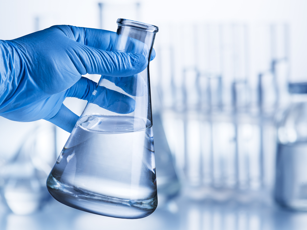 laboratory-beaker-analysts-hand-plastic-glove-524463133